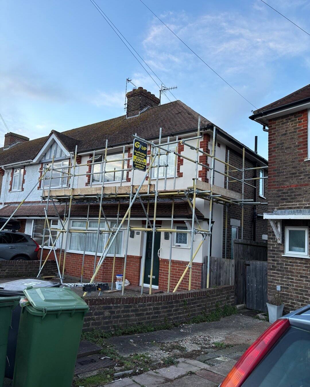Scaffold tower around a semi-detached house extension