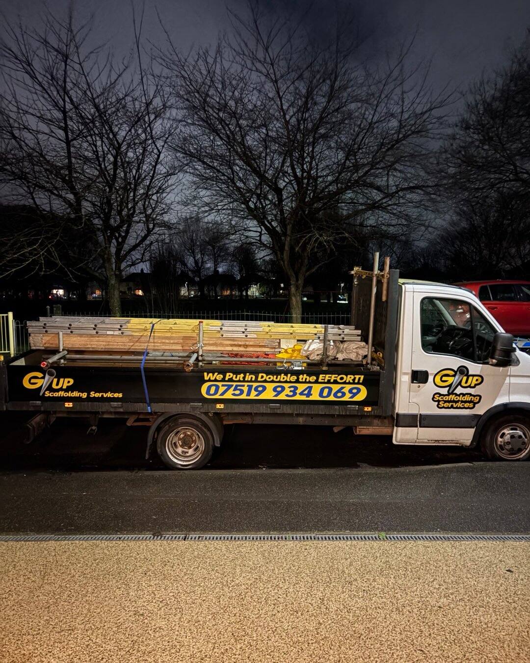 G/UP Scaffolding Services flatbed truck loaded with scaffold tube and boards